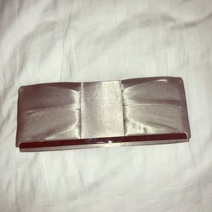 Jessica McClintock silver satin evening clutch.